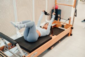 a woman is doing exercises on a rowing machine